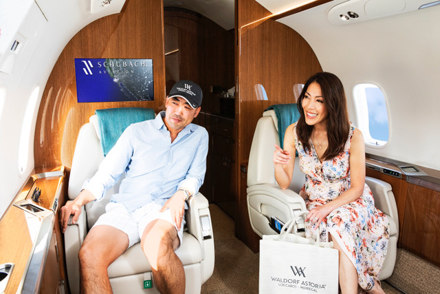 Man and woman enjoying their flight on a private jet